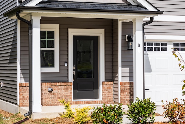 view of exterior entry featuring a garage