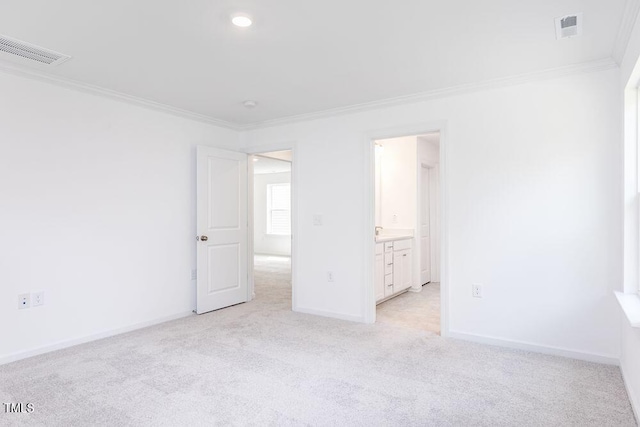 spare room featuring crown molding and light colored carpet