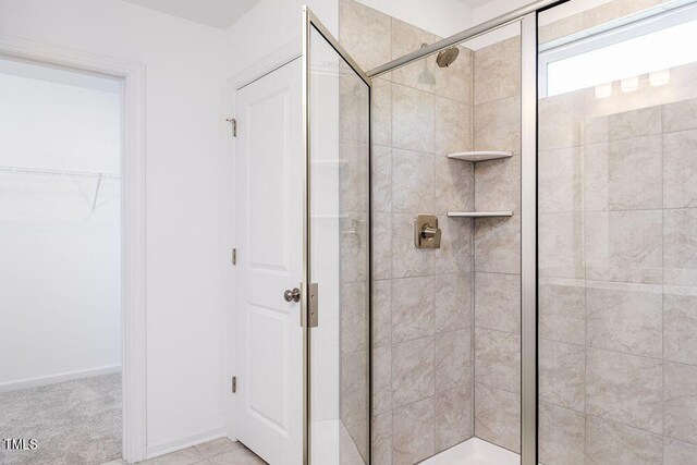 bathroom featuring a shower with shower door