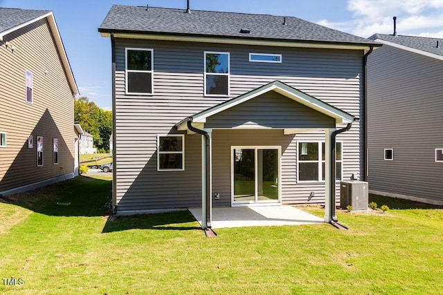 rear view of property featuring a patio, a yard, and cooling unit