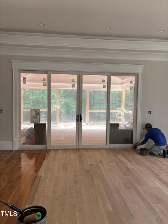 8305 Society Pl, Raleigh, NC 27615 - doorway with french doors, light wood finished floors, and crown molding