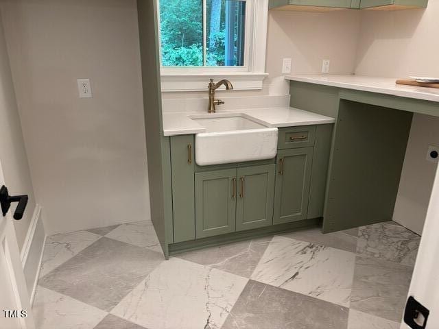 8305 Society Pl, Raleigh, NC 27615 - kitchen featuring green cabinets, light countertops, and light marble finish floors
