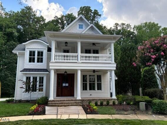 8305 Society Pl, Raleigh, NC 27615 - greek revival house featuring a balcony, a porch, and a ceiling fan