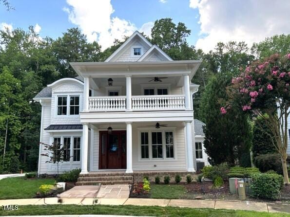 8305 Society Pl, Raleigh, NC 27615 - neoclassical home with a balcony, a ceiling fan, and a porch