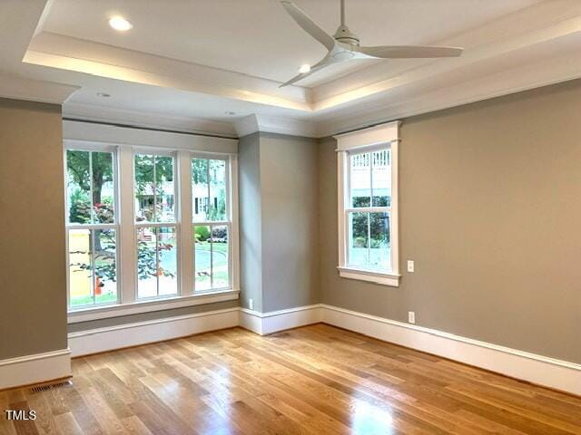 8305 Society Pl, Raleigh, NC 27615 - spare room with a raised ceiling, ceiling fan, wood finished floors, ornamental molding, and recessed lighting