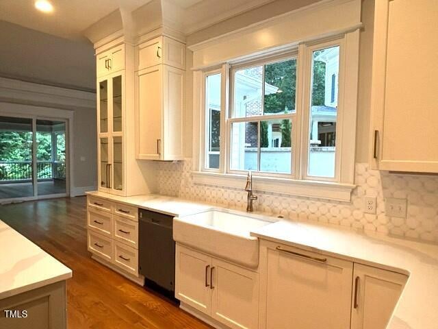 8305 Society Pl, Raleigh, NC 27615 - kitchen with black dishwasher, healthy amount of natural light, dark wood-style floors, and light countertops