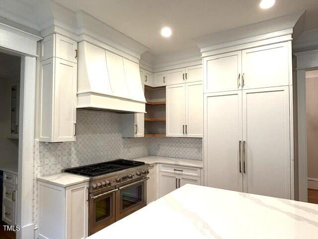 8305 Society Pl, Raleigh, NC 27615 - kitchen featuring double oven range, custom exhaust hood, open shelves, tasteful backsplash, and recessed lighting