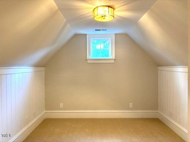 8305 Society Pl, Raleigh, NC 27615 - additional living space featuring light carpet and vaulted ceiling