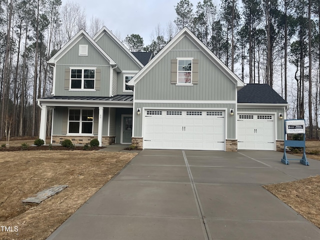 craftsman inspired home featuring a porch and a garage