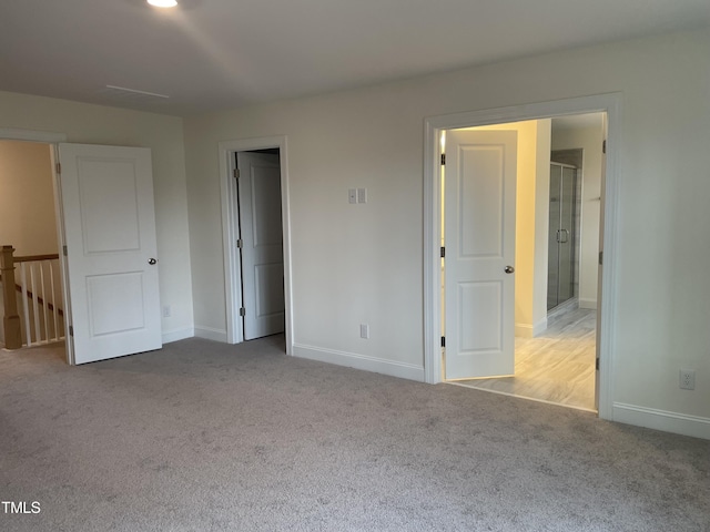 unfurnished bedroom with light colored carpet