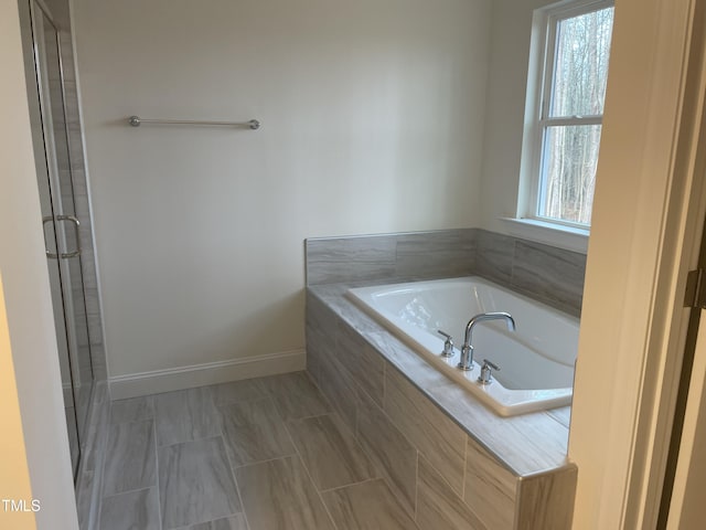 bathroom with shower with separate bathtub