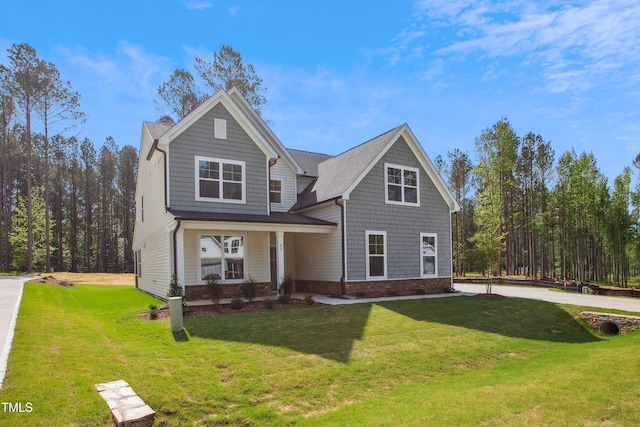 traditional-style house featuring a porch and a front yard