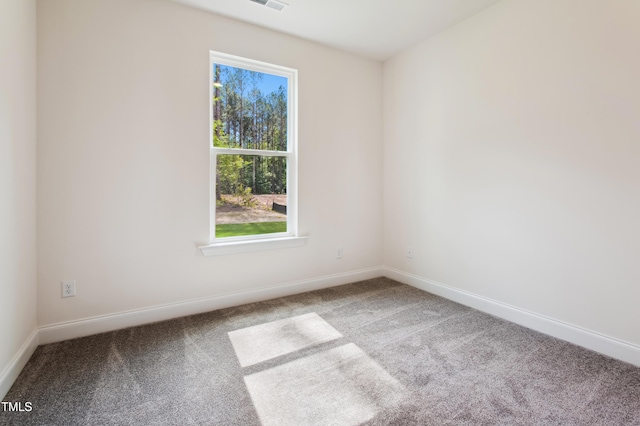 unfurnished room featuring baseboards, carpet, and visible vents