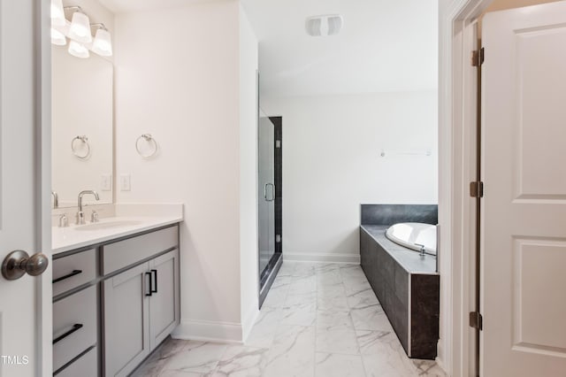 full bathroom with vanity, baseboards, a garden tub, and marble finish floor