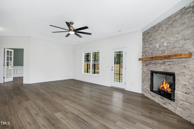 unfurnished living room with crown molding, a fireplace, ceiling fan, and wood-type flooring