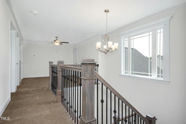 hallway with carpet floors and an inviting chandelier