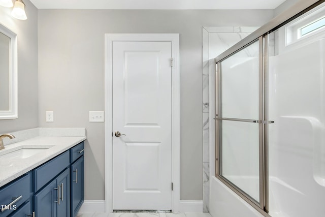 bathroom with vanity and combined bath / shower with glass door