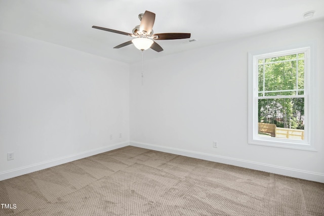 carpeted empty room featuring ceiling fan