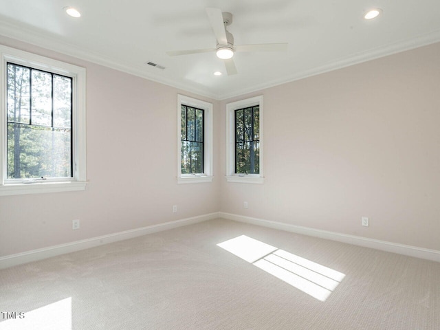 carpeted empty room featuring crown molding and ceiling fan