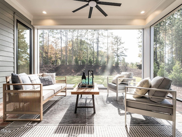 sunroom featuring ceiling fan and a wealth of natural light