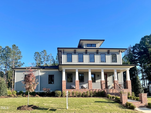 view of front of house featuring a front yard and covered porch