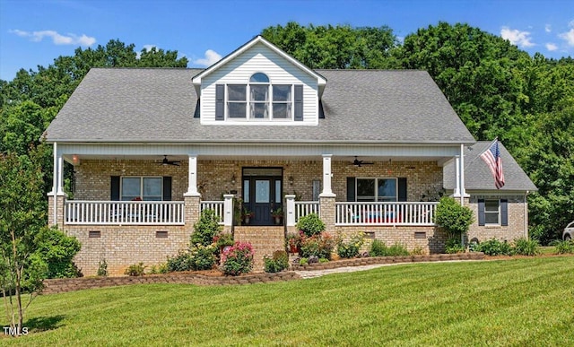 view of front of house with a front lawn, ceiling fan, and a porch