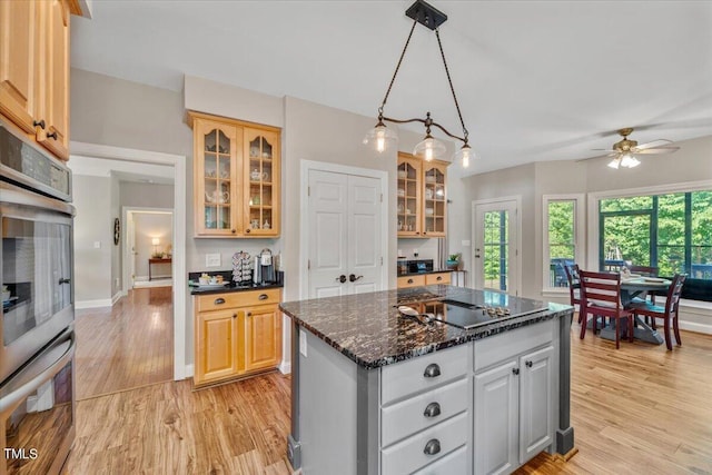 kitchen featuring double oven, plenty of natural light, black electric cooktop, and light wood finished floors