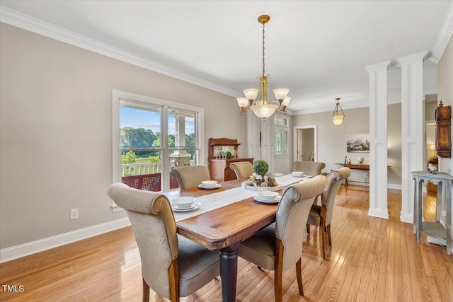 dining room with crown molding, baseboards, light wood-style flooring, and a notable chandelier