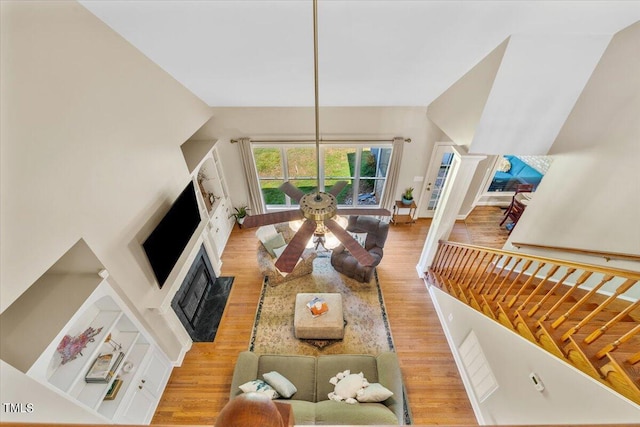 living room with wood finished floors and a fireplace