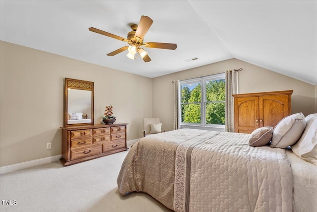 bedroom with light colored carpet, visible vents, a ceiling fan, baseboards, and vaulted ceiling