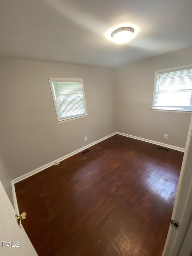 empty room featuring dark hardwood / wood-style flooring