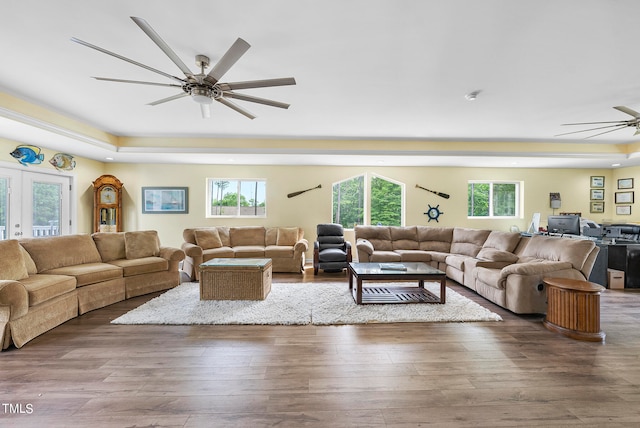 living room featuring ceiling fan, french doors, hardwood / wood-style floors, and a wealth of natural light