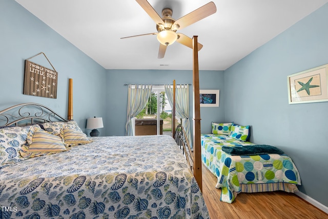 bedroom with hardwood / wood-style floors, ceiling fan, and access to exterior