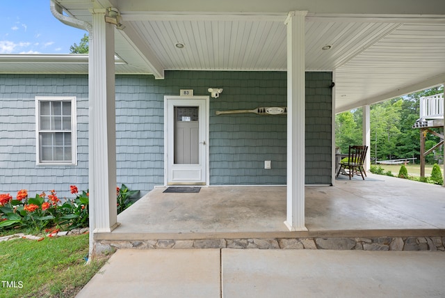 view of exterior entry featuring a porch