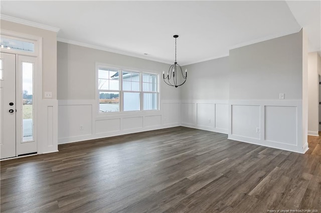 unfurnished dining area with dark hardwood / wood-style flooring, crown molding, and an inviting chandelier