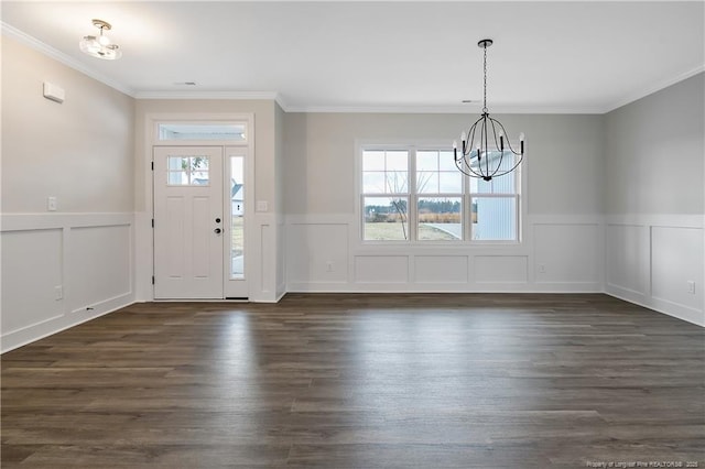 entryway with dark hardwood / wood-style flooring, crown molding, and a chandelier