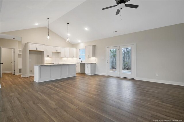 unfurnished living room featuring sink, high vaulted ceiling, dark hardwood / wood-style floors, and ceiling fan