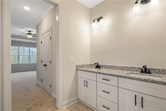 bathroom featuring vanity, ornamental molding, and ceiling fan