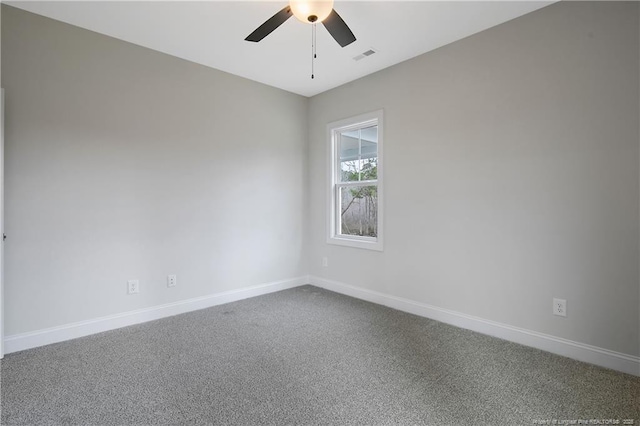 empty room featuring ceiling fan and carpet