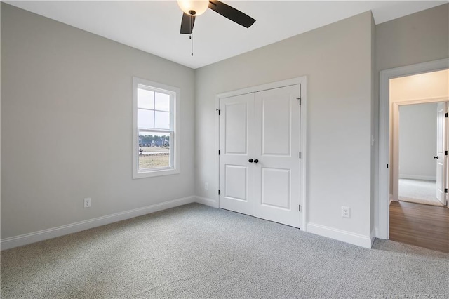 unfurnished bedroom with carpet floors, a closet, and ceiling fan