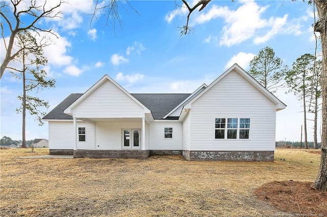 rear view of property featuring a yard