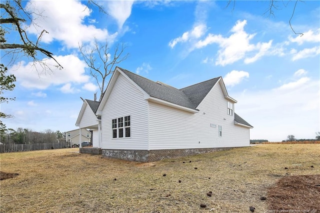 view of side of home featuring a yard