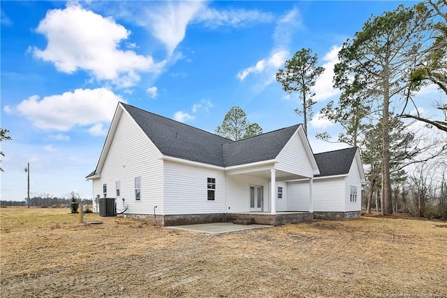 view of side of home with a patio and central air condition unit