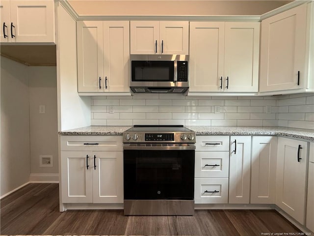 1237 Joe Hall Rd, Hope Mills, NC 28348 - kitchen featuring stainless steel appliances, dark wood-style flooring, tasteful backsplash, and light stone counters