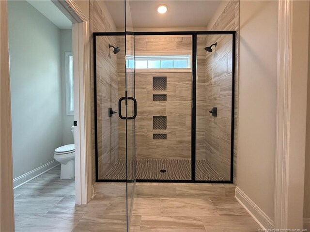 1237 Joe Hall Rd, Hope Mills, NC 28348 - bathroom featuring toilet, a shower stall, and baseboards