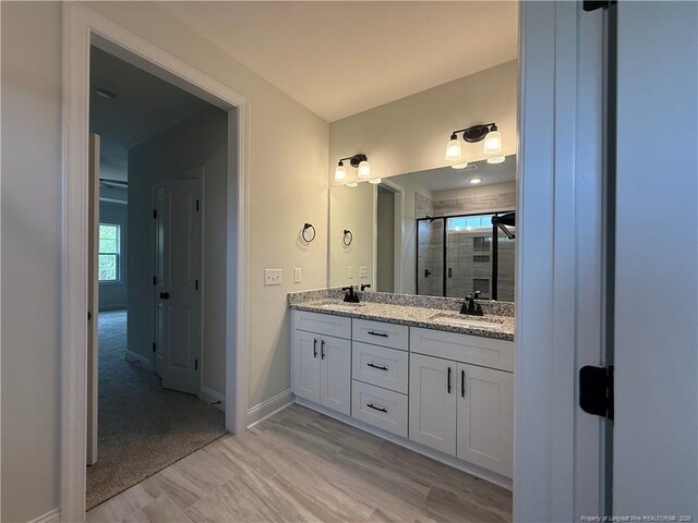 1237 Joe Hall Rd, Hope Mills, NC 28348 - bathroom with double vanity, a shower stall, and baseboards