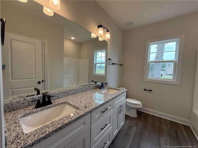 1237 Joe Hall Rd, Hope Mills, NC 28348 - full bathroom featuring baseboards, wood finished floors, double vanity, toilet, and a shower