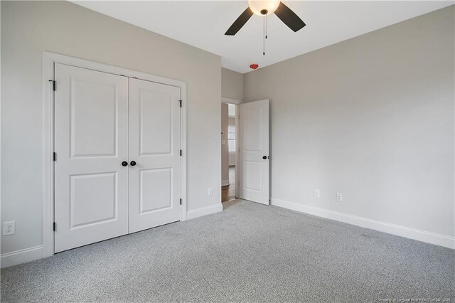 1237 Joe Hall Rd, Hope Mills, NC 28348 - unfurnished bedroom featuring carpet floors, baseboards, a closet, and a ceiling fan