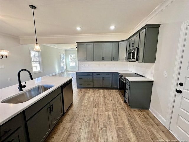 kitchen with gray cabinets, appliances with stainless steel finishes, sink, and pendant lighting