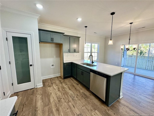 kitchen with pendant lighting, dishwasher, wood-type flooring, sink, and crown molding